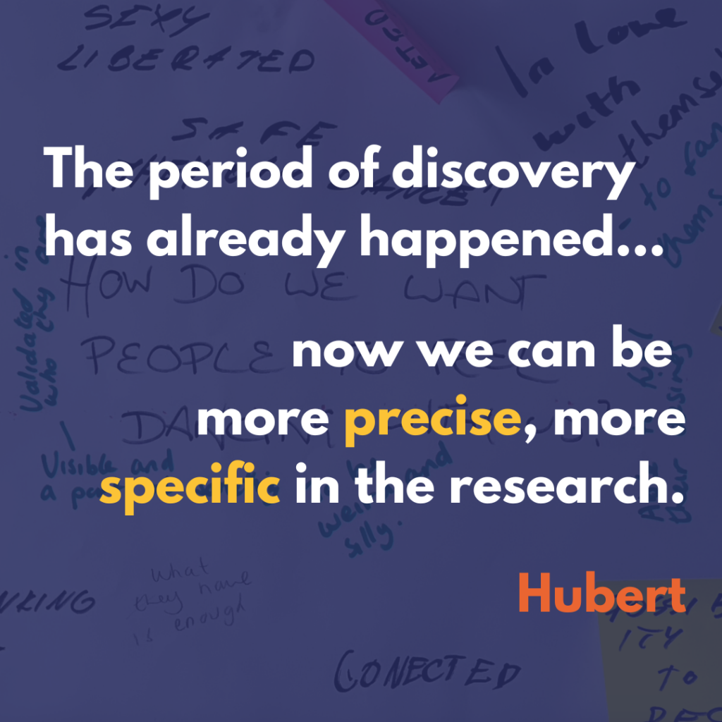 This text written on a semi-transparent blue background laid over image of black writing and colourful post-it notes on white paper: The period of discovery has already happened... now we can be more precise, more specific in the research. Hubert